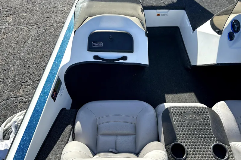 Slide: The Image of Interior of a 2003 Champion 187 CX boat with seating and dashboard. - 31