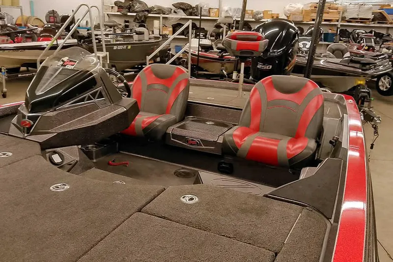 Slide: The Image of 2021 Ranger Z520L boat interior with red and gray seats in a showroom. - 27