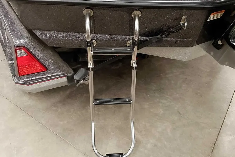 Slide: The Image of 2021 Ranger Z520L boat with a stainless steel boarding ladder on concrete floor. - 32