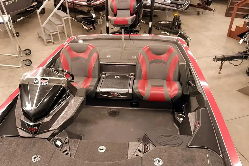 Slide: The Image of 2021 Ranger Z520L boat interior with red and gray seats in showroom. - 47