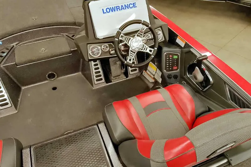 Slide: The Image of 2021 Ranger Z520L boat cockpit with Lowrance display, red and gray seating, and steering wheel. - 52