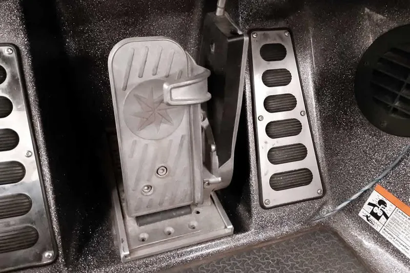 Slide: The Image of 2021 Ranger Z520L boat pedal and footrest in metallic interior. - 53
