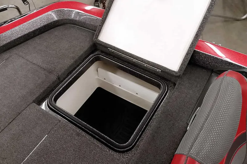 Slide: The Image of Open storage compartment in 2021 Ranger Z520L boat, featuring red and gray interior. - 57