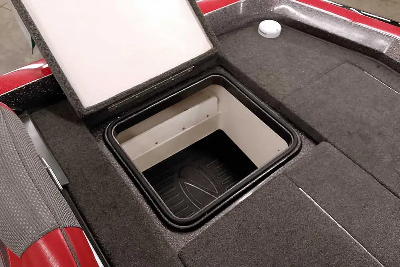 Slide: The Image of Open storage compartment on 2021 Ranger Z520L boat deck, featuring carpeted interior. - 58