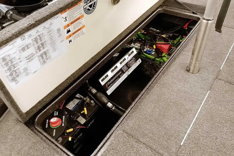 Slide: The Image of 2021 Ranger Z520L boat battery compartment with wiring and warning labels. - 59