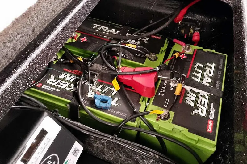 Slide: The Image of Tracker lithium batteries in a 2021 Ranger Z520L boat, connected with cables. - 61