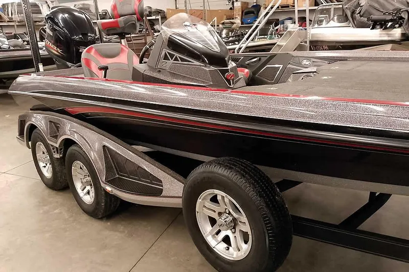 Slide: The Image of 2021 Ranger Z520L bass boat with sleek design and triple-axle trailer. - 63