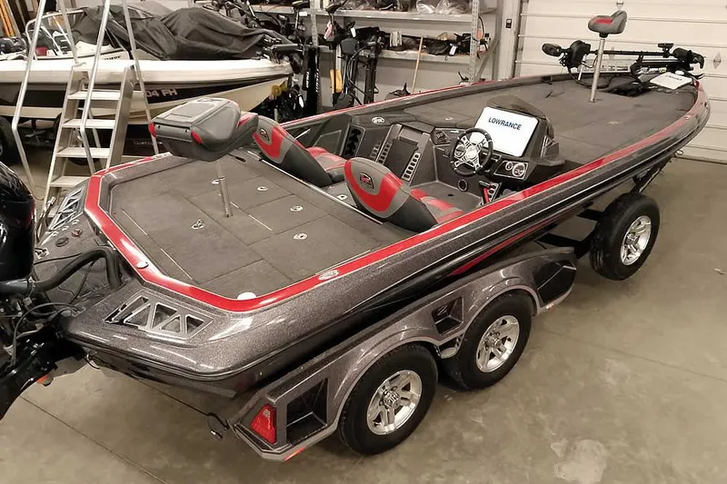 Slide: The Image of 2021 Ranger Z520L bass boat in garage, featuring dual seats and advanced navigation system. - 64