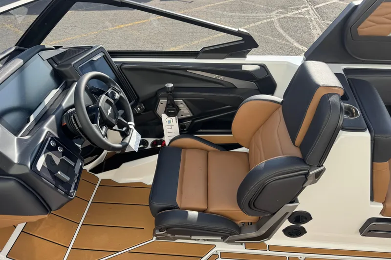 Slide: The Image of Interior of 2026 Supra SV 575 boat with modern steering and tan leather seating. - 8