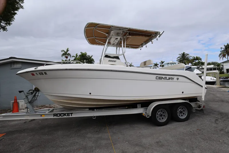 The Image of 2018 Century 2200 Center Console boat on trailer, parked outdoors. - 1