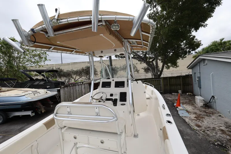 Slide: The Image of 2018 Century 2200 Center Console boat with T-top in a yard setting. - 10