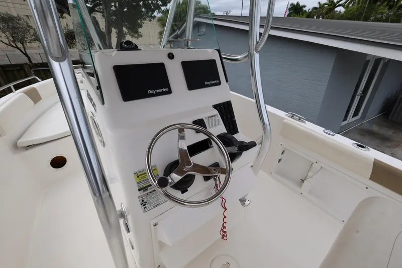 Slide: The Image of 2018 Century 2200 Center Console boat with Raymarine electronics and steering wheel. - 12