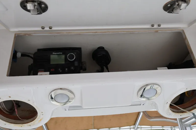 Slide: The Image of Open storage compartment on 2018 Century 2200 Center Console boat with Raymarine equipment. - 14