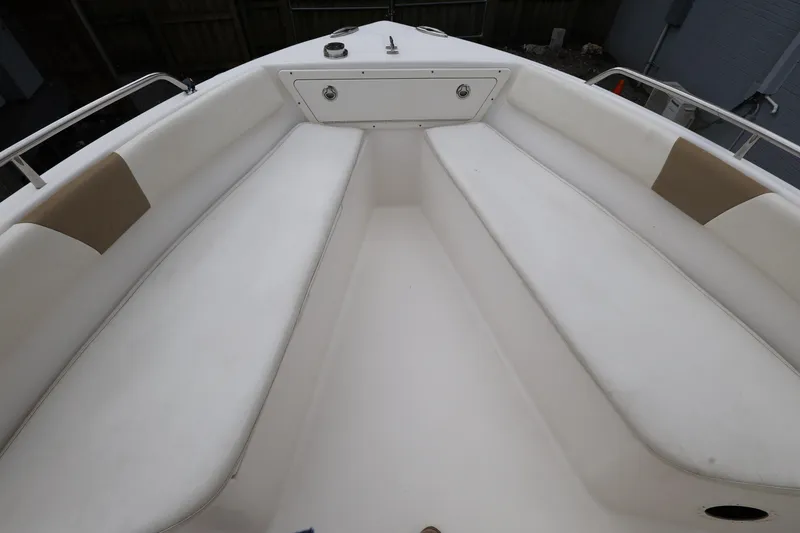 Slide: The Image of 2018 Century 2200 Center Console boat interior with cushioned seating and storage. - 16