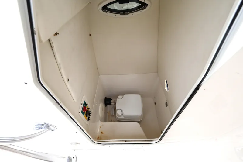 Slide: The Image of 2018 Century 2200 Center Console boat interior with compact marine toilet. - 19