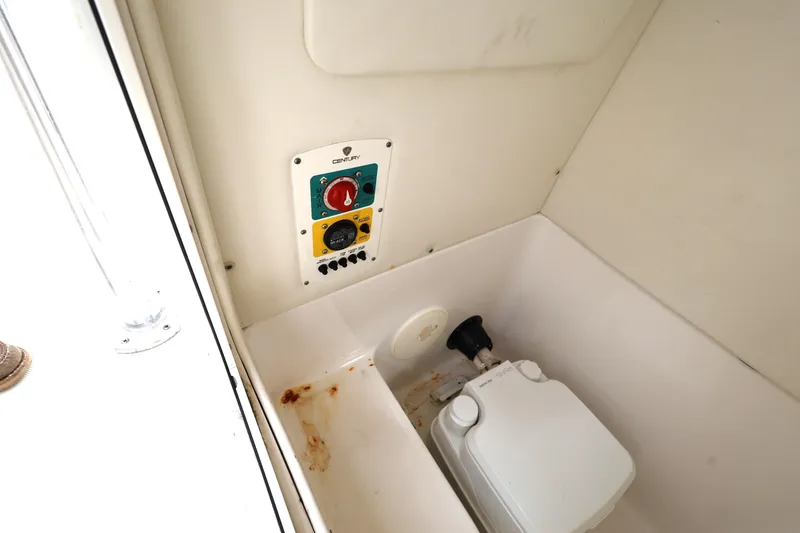 Slide: The Image of 2018 Century 2200 Center Console boat interior with control panel and toilet. - 20