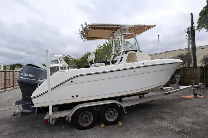 Slide: The Image of 2018 Century 2200 Center Console boat on trailer with Yamaha engine, parked outdoors. - 7