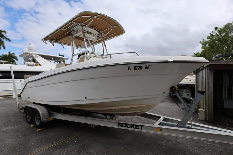 Slide: The Image of 2018 Century 2200 Center Console boat on trailer, parked outdoors. - 8
