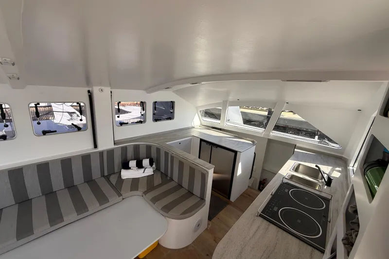 Slide: The Image of Interior of 2023 Schionning 1850 S catamaran with modern kitchen and seating area. - 13