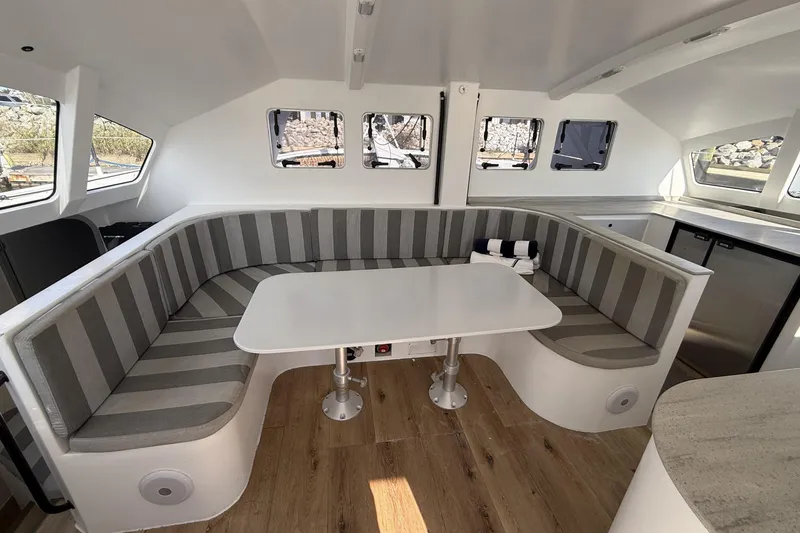 Slide: The Image of Modern interior of 2023 Schionning 1850 S catamaran with striped seating and sleek design. - 14