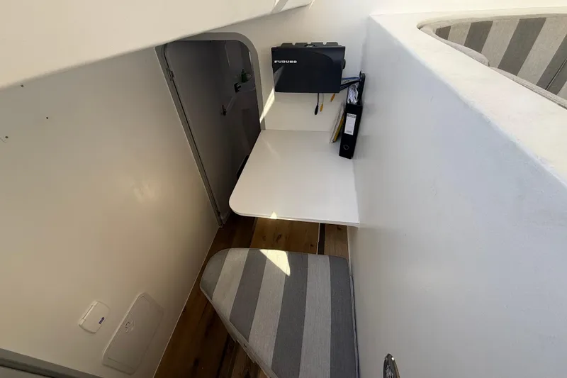 Slide: The Image of Compact workspace in 2023 Schionning 1850 S yacht with striped seating and white desk. - 24