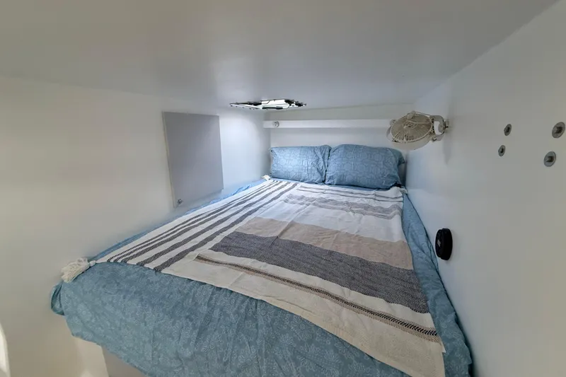 Slide: The Image of Cozy cabin interior of 2023 Schionning 1850 S with a neatly made bed. - 26