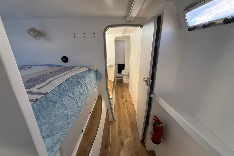 Slide: The Image of 2023 Schionning 1850 S interior with bed, wooden floor, and bathroom. - 27