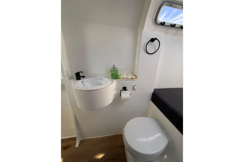 Slide: The Image of Modern bathroom in 2023 Schionning 1850 S yacht with sink, toilet, and window. - 28