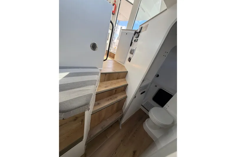 Slide: The Image of Interior of 2023 Schionning 1850 S yacht with wooden stairs and compact bathroom. - 29