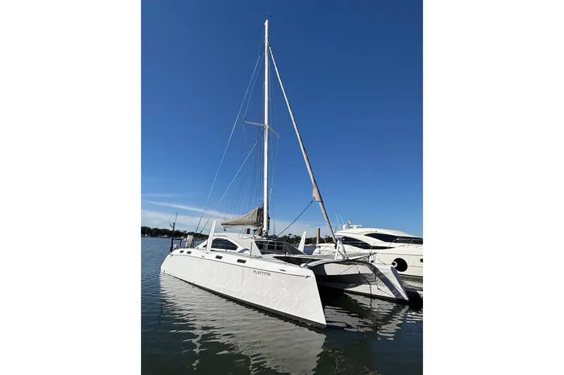 Slide: The Image of 2023 Schionning 1850 S catamaran docked on calm water under clear blue sky. - 3