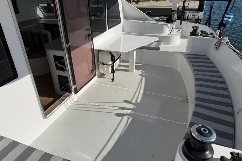 Slide: The Image of 2023 Schionning 1850 S yacht cockpit with seating, table, and interior view. - 31