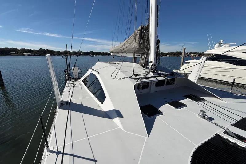 Slide: The Image of 2023 Schionning 1850 S catamaran docked on a sunny day, showcasing sleek design. - 8