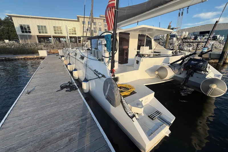 Slide: The Image of 2023 Schionning 1850 S catamaran docked at marina, showcasing sleek design and modern features. - 9