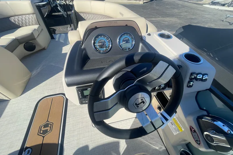 Slide: The Image of 2026 Harris Cruiser 210 boat dashboard with steering wheel and gauges. - 10