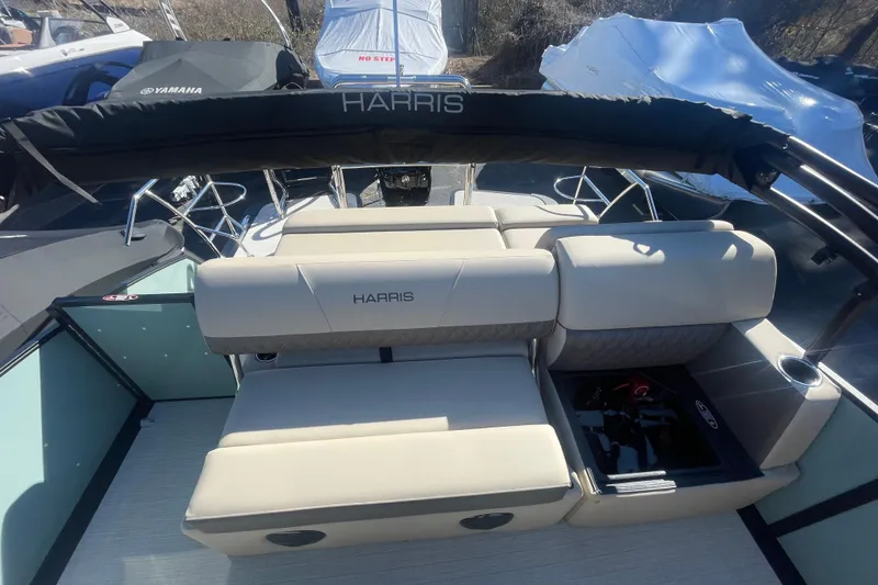 Slide: The Image of 2026 Harris Cruiser 210 boat interior with beige seating and storage compartments. - 11