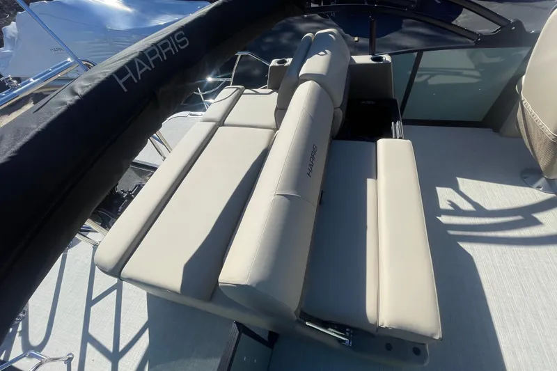 Slide: The Image of 2026 Harris Cruiser 210 boat interior with beige seating and Harris branding. - 13
