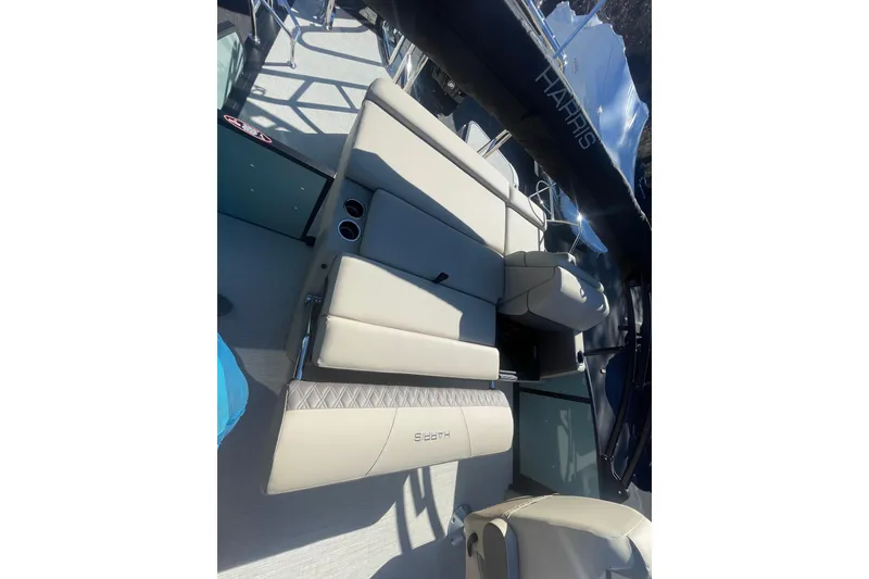Slide: The Image of 2026 Harris Cruiser 210 boat interior with beige seating and cup holders. - 15