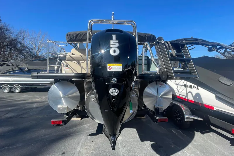 Slide: The Image of 2026 Harris Cruiser 210 boat with powerful 150 HP engine, parked outdoors. - 4