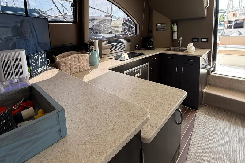 Slide: The Image of Interior of 2013 Carver C34 yacht featuring modern kitchen and entertainment area. - 15