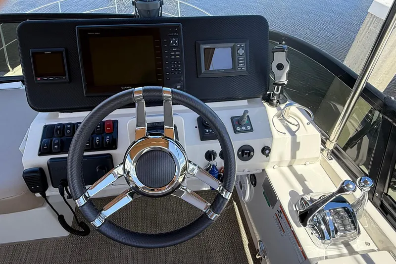 Slide: The Image of Helm of 2013 Carver C34 yacht with steering wheel and navigation controls. - 23