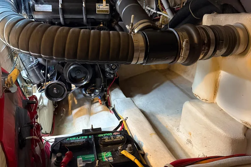 Slide: The Image of Engine compartment of a 2013 Carver C34 boat, featuring battery and mechanical components. - 34