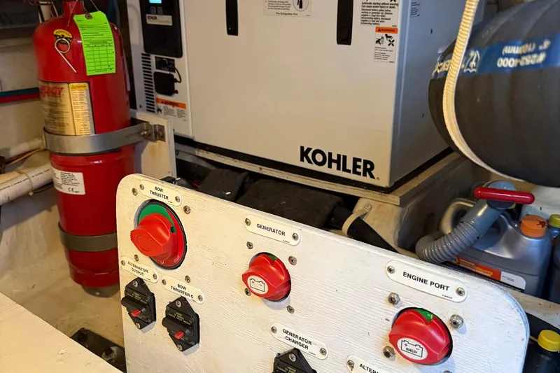 Slide: The Image of Engine room of 2013 Carver C34 with Kohler generator and fire extinguisher. - 36