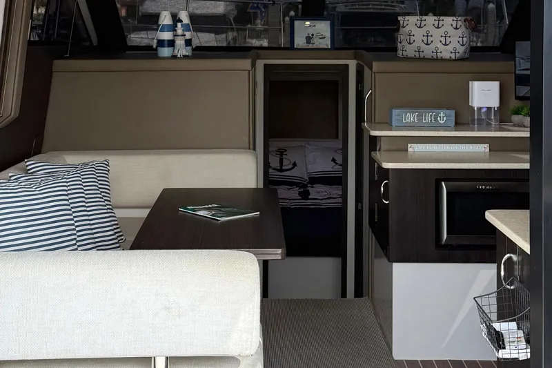 Slide: The Image of Interior of a 2013 Carver C34 yacht with cozy seating and nautical decor. - 7