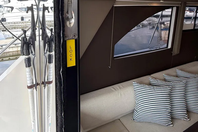 Slide: The Image of Interior of 2013 Carver C34 yacht with striped cushions and lock mechanism. - 9
