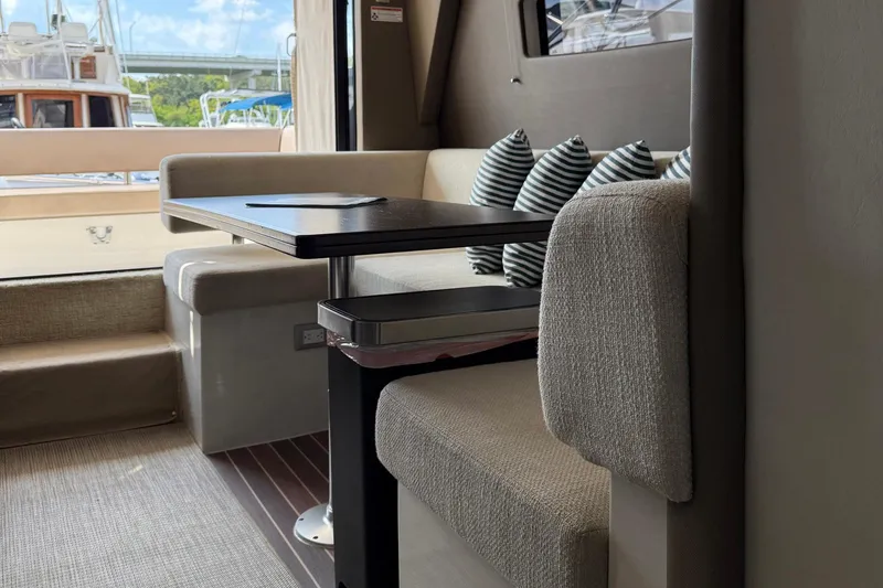 Slide: The Image of Interior of 2013 Carver C34 yacht with cozy seating and striped cushions. - 11