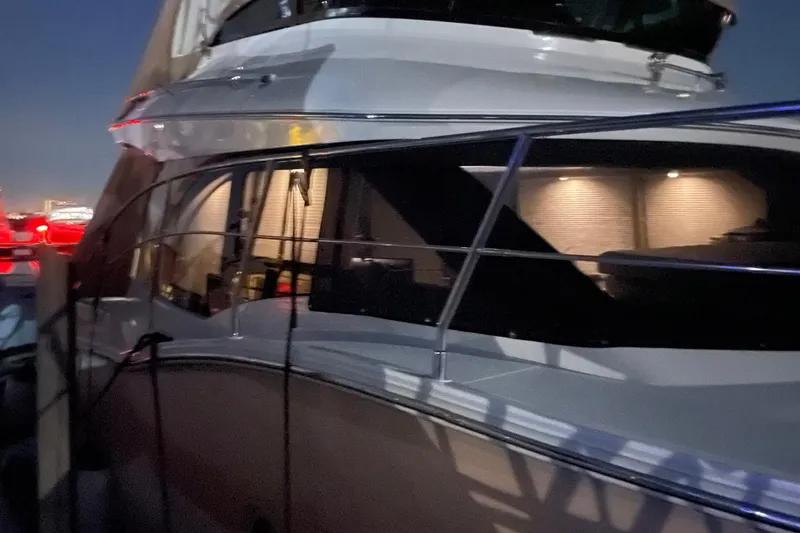 Slide: The Image of 2013 Carver C34 yacht docked at night with illuminated interior. - 20