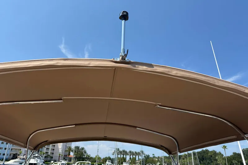 Slide: The Image of 2013 Carver C34 boat canopy under clear blue sky. - 27