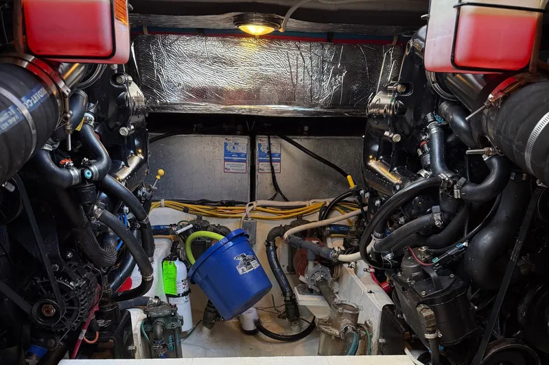 Slide: The Image of Engine room of a 2013 Carver C34 boat, showcasing complex machinery and components. - 32