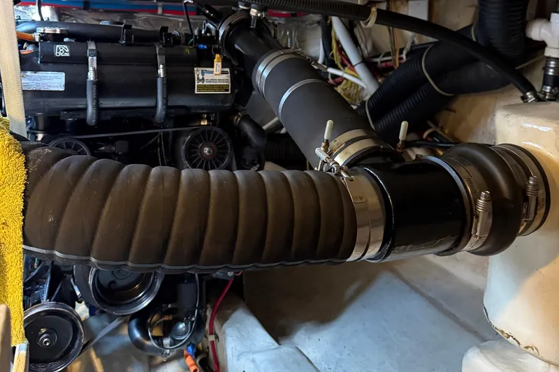 Slide: The Image of Engine compartment of 2013 Carver C34 boat with hoses and mechanical components. - 35