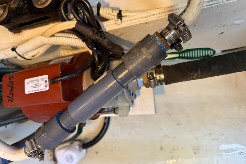 Slide: The Image of Engine compartment of a 2013 Carver C34 with visible hoses and clamps. - 39